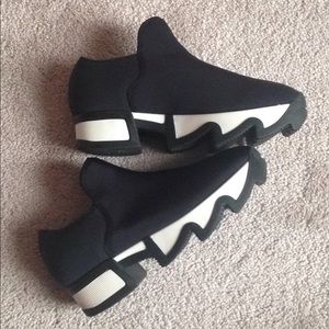 IRI black outline neoprene sneaker.